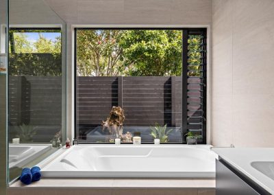Bathroom utilises fixed glass and Breezway Louvres